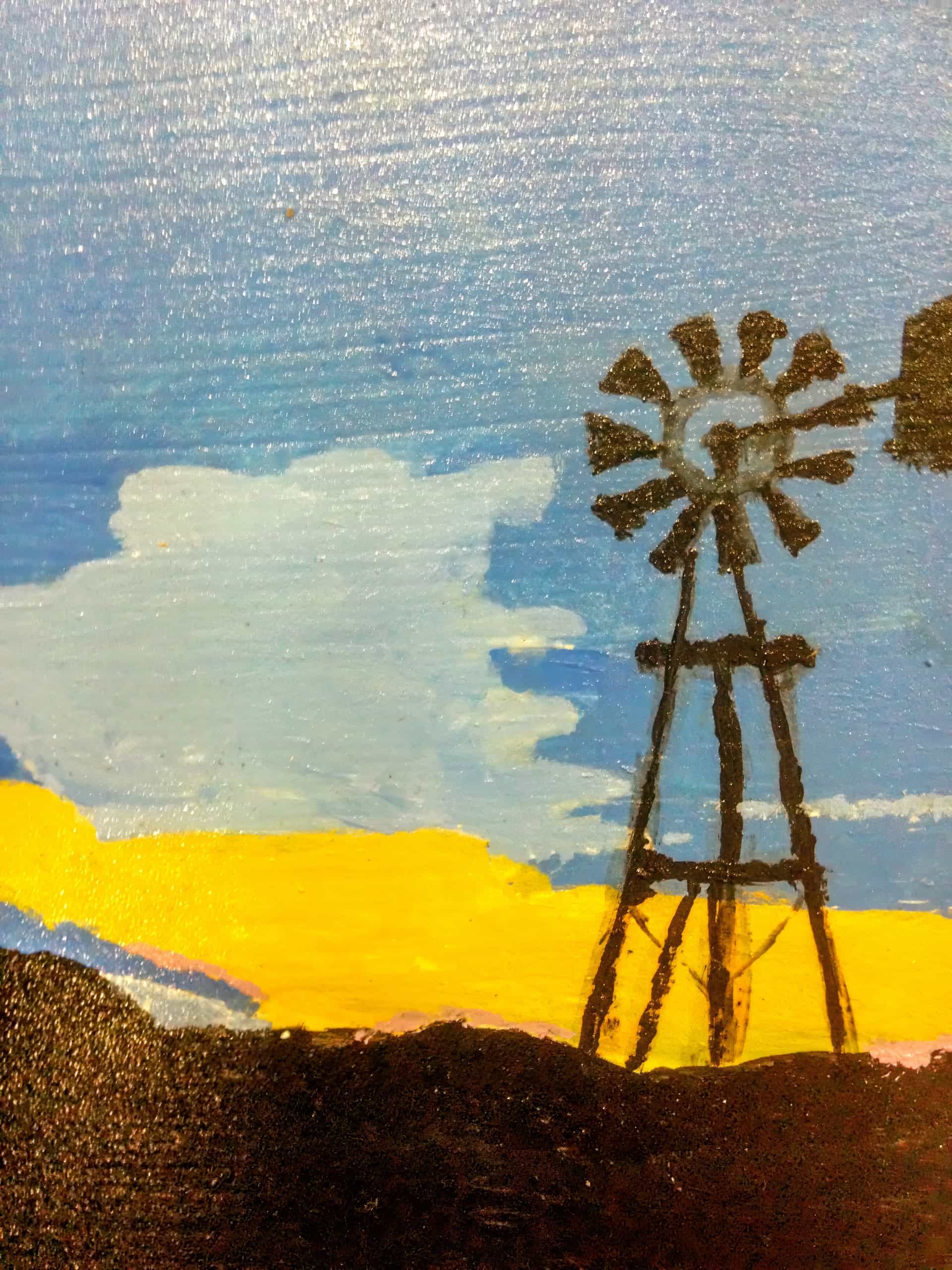A painting of a windmill in silhouette stands against a vibrant sky. The sky fades from blue at the top to yellow near the horizon, with soft white clouds and a dark landscape in the foreground. The windmill blades and structure are simply outlined.