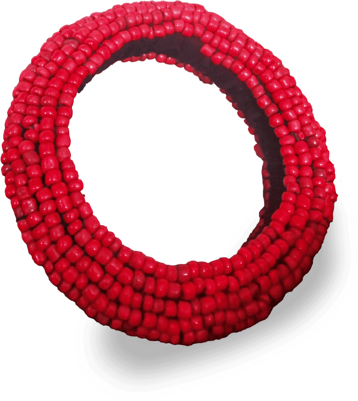A coiled bracelet made of multiple strands of small, round, shiny red beads. The beads are strung closely together, forming a thick, flexible band. The bracelet’s coils overlap, creating a spiral effect against a white background.
