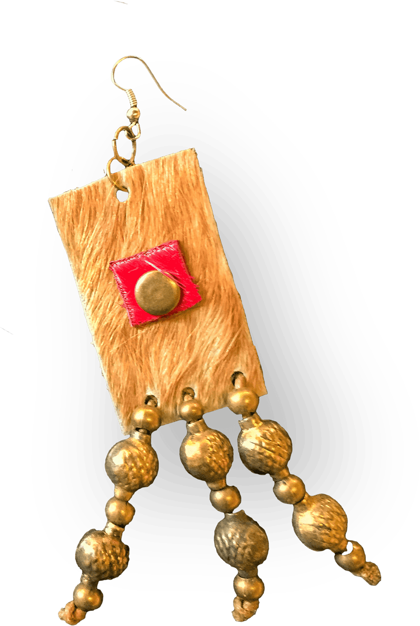 A handmade earring with a rectangular, tan textured base, a small red square and brass stud in the centre, featuring three strands of round, textured golden beads hanging below. The earring has a hook for wearing. The background is black.