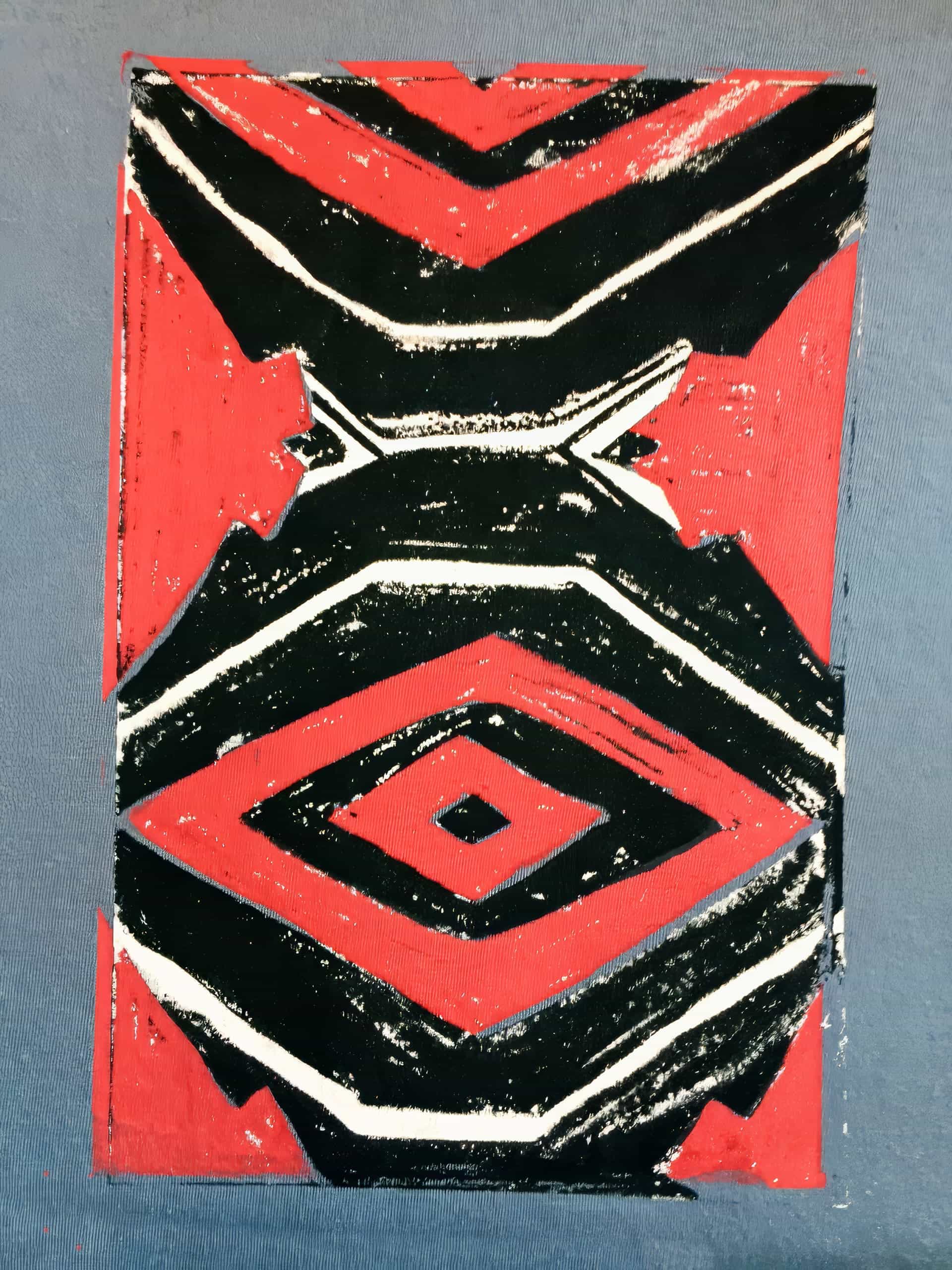 A rectangular abstract design features bold, jagged black and white lines over a red background, forming geometric shapes resembling diamonds and chevrons. The artwork has a rough, textured appearance and rests on a muted blue surface.