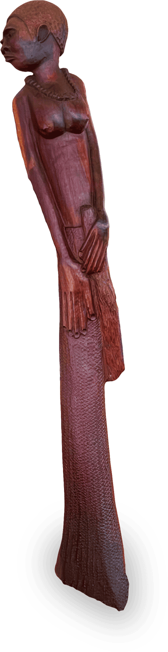 A tall, slender wooden sculpture of a woman with a beaded necklace, stylised facial features, elongated arms, and a textured long skirt; her hands are posed together at her waist, and she gazes to the side with a serene expression.