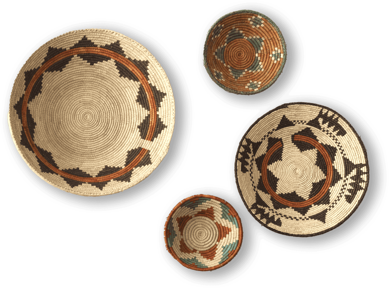Four round, woven baskets with intricate geometric patterns in earthy tones—tan, brown, black, green, and orange—are displayed against a black background. The baskets vary in size, with two large and two smaller ones arranged asymmetrically.
