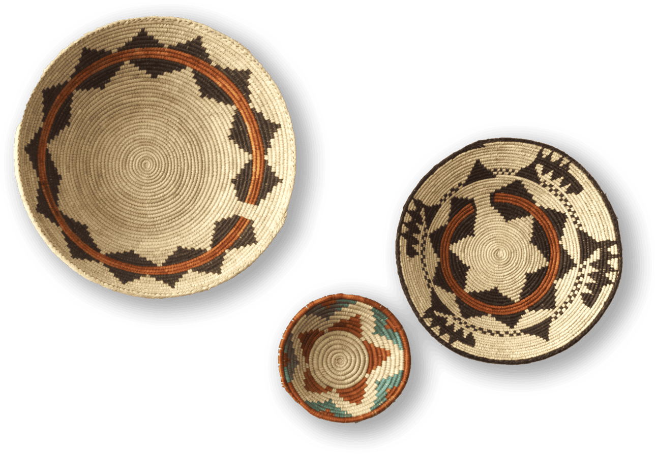 Three woven baskets are displayed against a black background. Each features intricate geometric patterns in earthy tones of brown, black, beige, and some greenish blue, with the two larger baskets showing star-like and zigzag designs, and the smallest basket having a colourful rim.