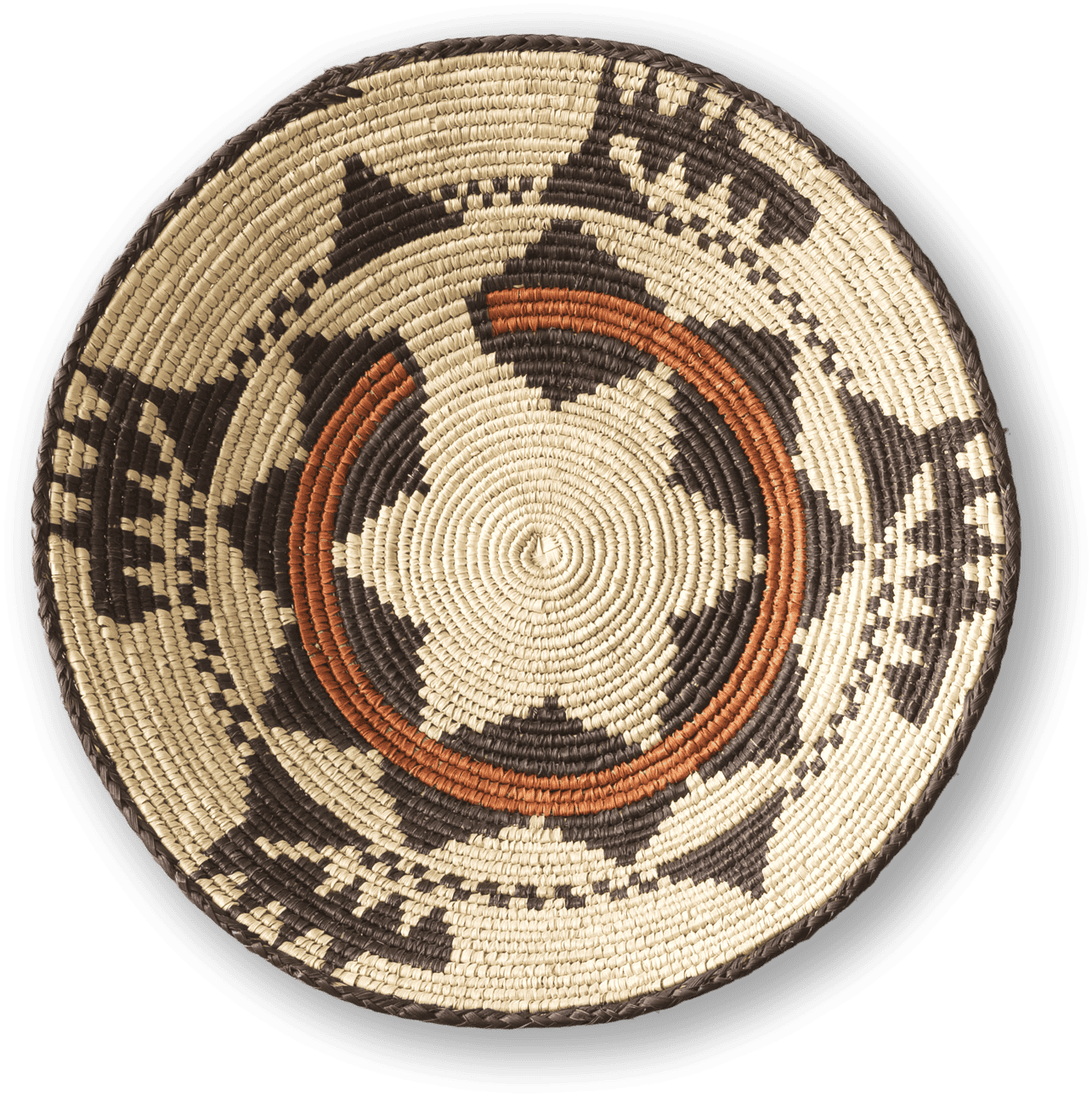 A round, woven basket lid features intricate black and tan geometric patterns and two curved orange bands. The design forms a star shape at the centre, with repeating triangles and zigzags along the edges. The basket has a coiled, textured appearance.