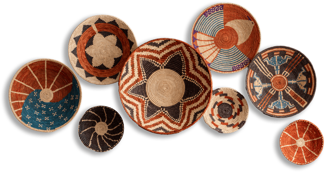 Nine woven baskets with intricate geometric and star patterns in earthy tones of orange, brown, blue, black, and white are arranged on a plain black background. Each basket features unique designs, including stripes, spirals, and concentric circles.