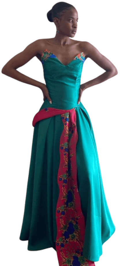 A woman in a teal strapless gown with a heart-shaped neckline, reminiscent of Contra.Joburg elegance. The dress features a pink panel with floral embroidery and a matching accent at the waist. She stands confidently, channelling the Weight of Silence, hair in a sleek bun.