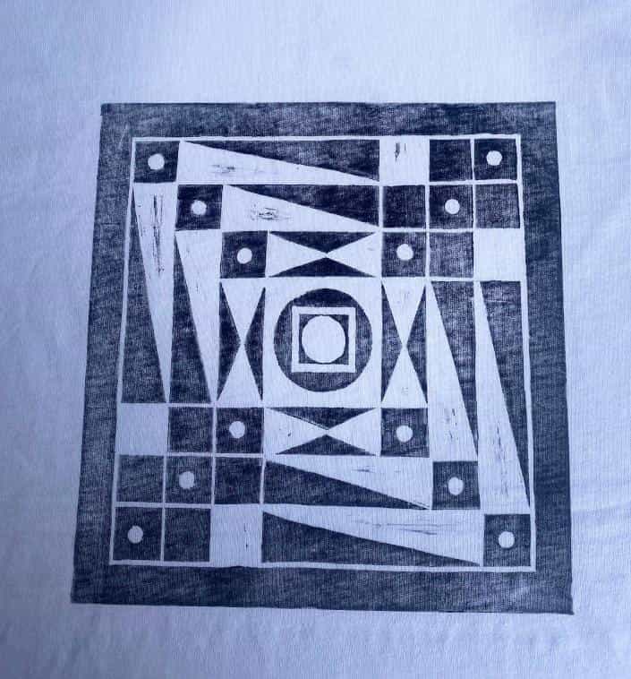 Black geometric print on white fabric showing a square filled with triangles, rectangles, circles, and a central concentric square pattern. The bold, abstract design evokes a modernist feel reminiscent of Contra.Joburg’s Weight of Silence.