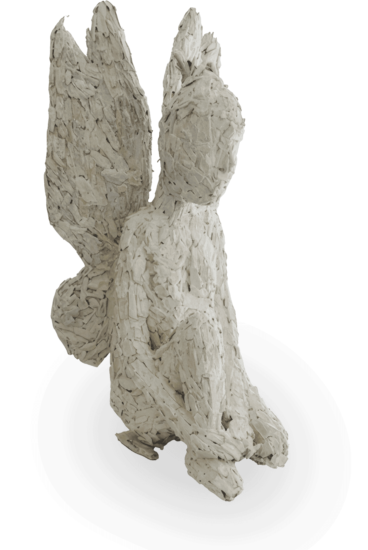 A textured sculpture titled The Weight of Silence, featured at Contra.Joburg, depicts a kneeling human figure with wings, crafted from overlapping pale wood. With a featureless face and rough, layered surfaces, it evokes quiet introspection.
